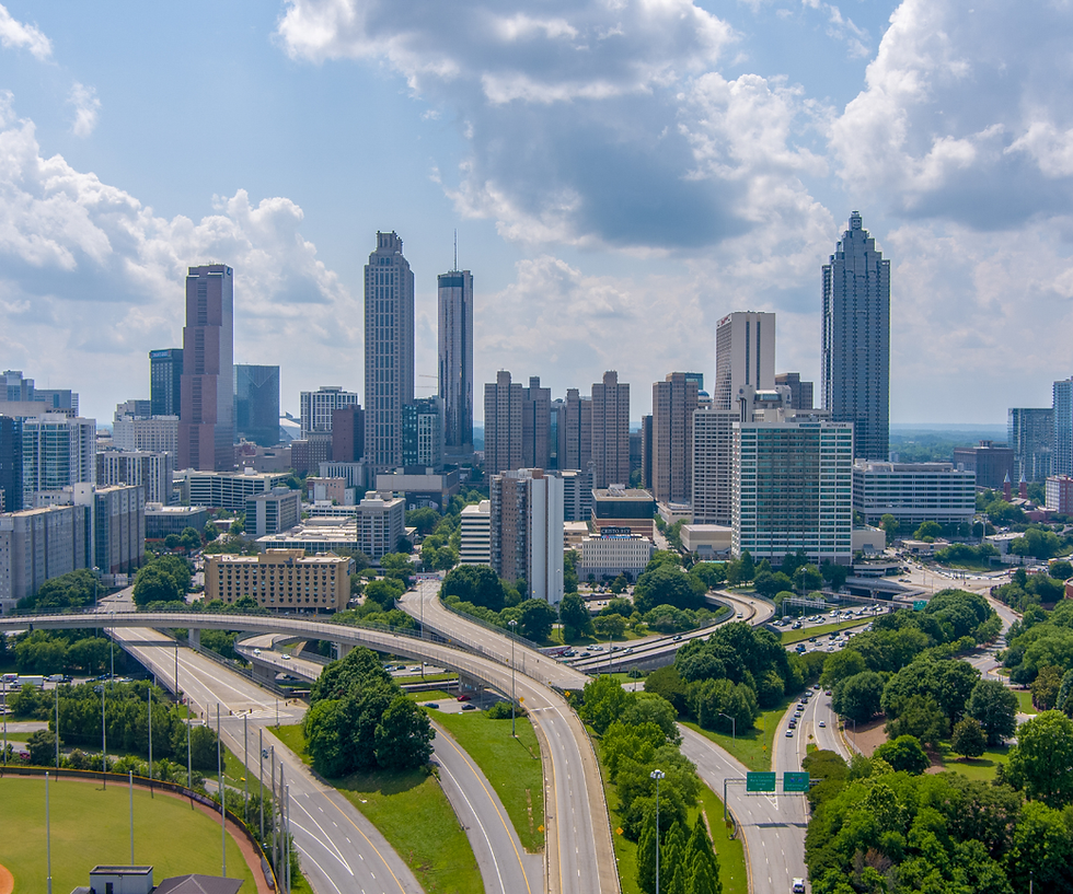 Aerial view of highways leading into Atlanta, Georgia with high-rise, downtown buildings in the background.