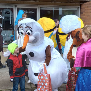 Characters posing with children for pictures