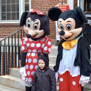 Mikey and Minnie taking picture with young child