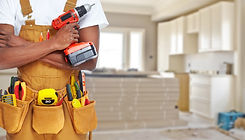 Builder handyman with construction tools. House renovation background..jpg