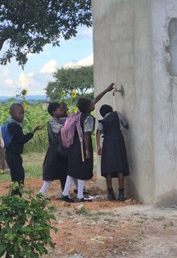 Above: Schoolchildren in Zambia receive clean water after the borehole project in a community where water had once been unavailable for 20 miles.
