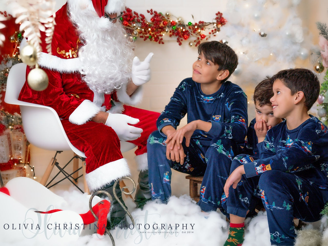 Family of four enjoying Hertfordshire Christmas photoshoot with santa in my Hertfordshire Studio