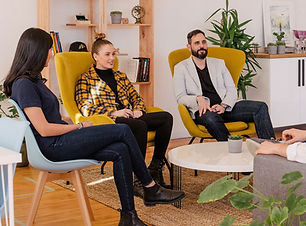 people seated together happily conversing.