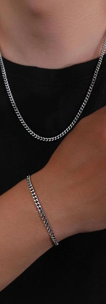 man wearing minimal stainless steel jewelry