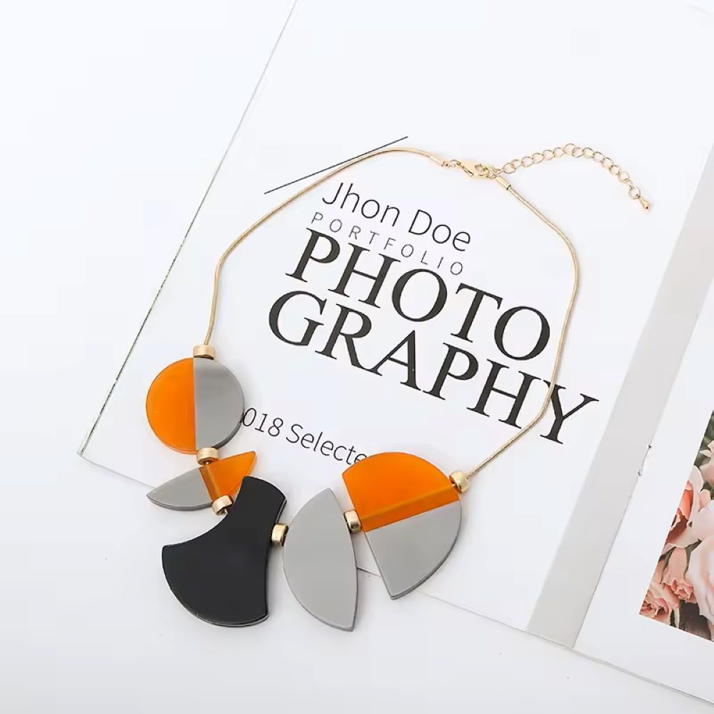 Firebird Acrylic Necklace, chunky shapes in black, orange & silver.