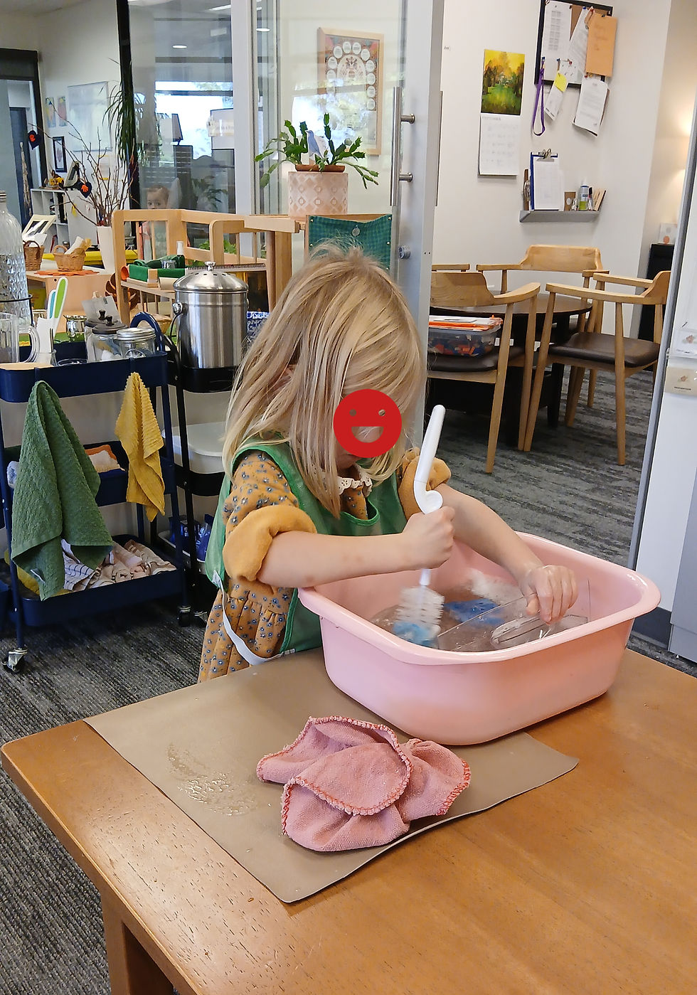Young scrubber in action: sleeves rolled up, determined to tackle the task with a splash of enthusiasm.