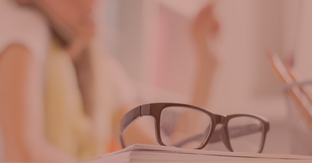 Eyeglasses sitting on a book.
