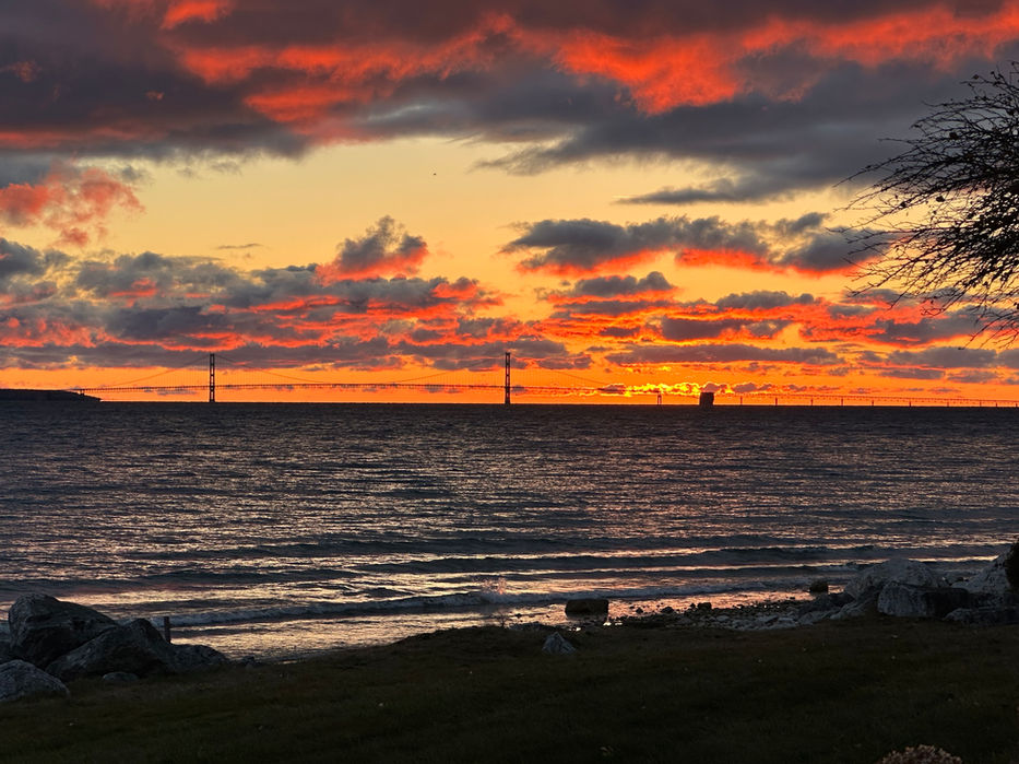 Fiery sunset over lake, two towers visible