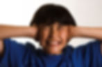 child holding ears looking uncomfortable