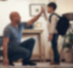 child with backpack giving adult high five