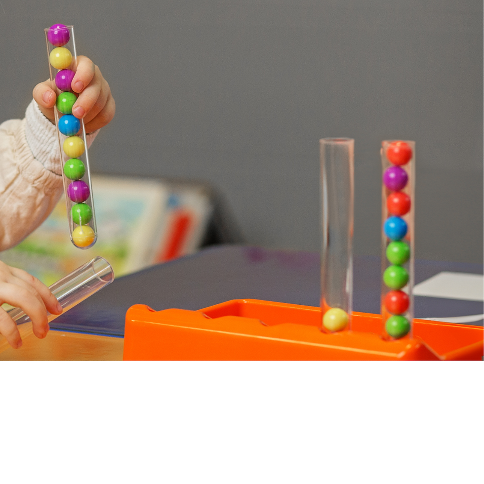 child activity consisting of 3 clear tubes with small balls in them and one with only one yellow ball.