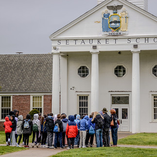Students outside of Setauket School with volunteer docents. Photo by Rob Pellegrino