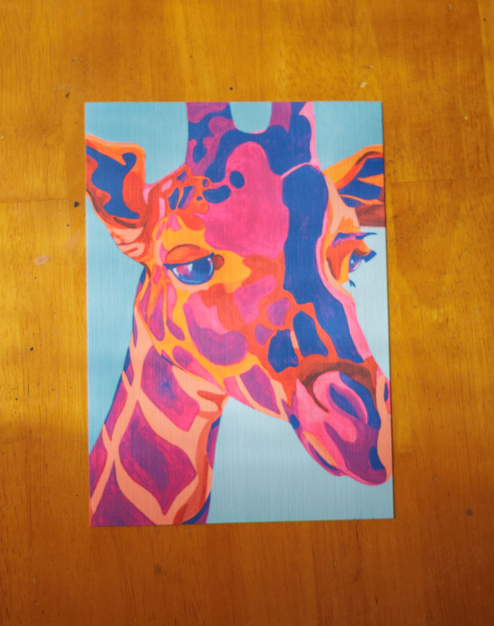 neon orange and pink giraffe with a blue background
