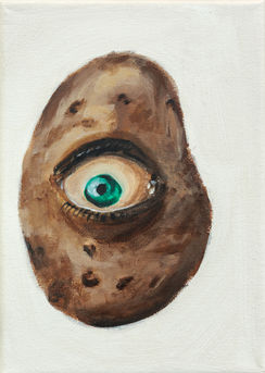a potato with a turquoise eyeball