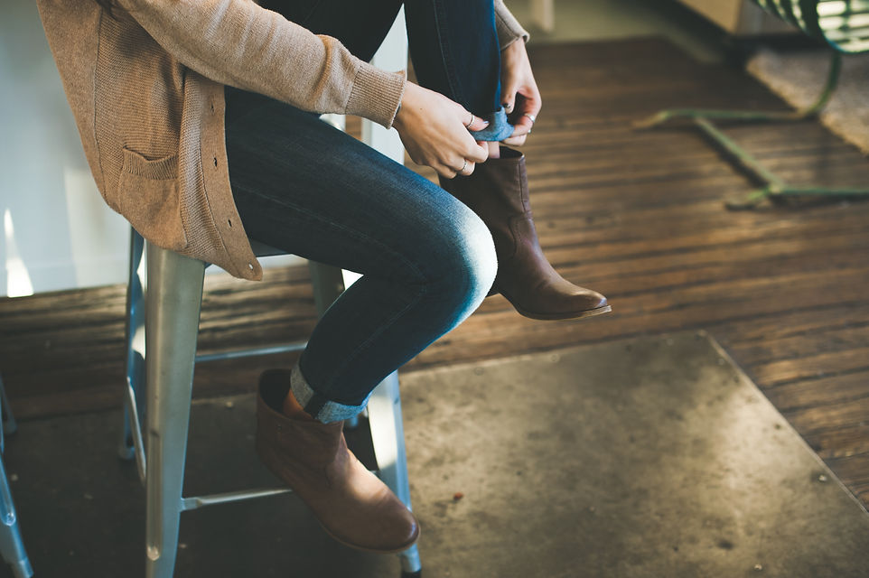 Fashionable Woman Putting on Boots