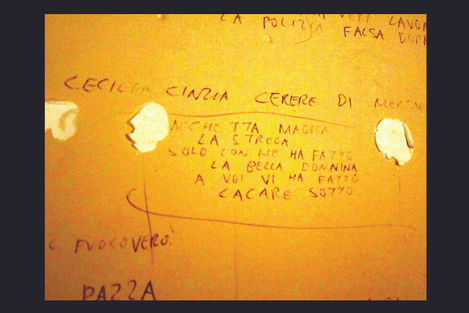 a yellow wall with graffiti on it