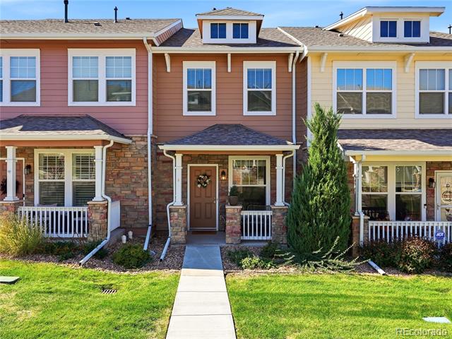 Updated MLS front exterior photo of 13752 Garfield Street Unit C, Thornton, Colorado, with covered porch, stone accents, and landscaped front walkway