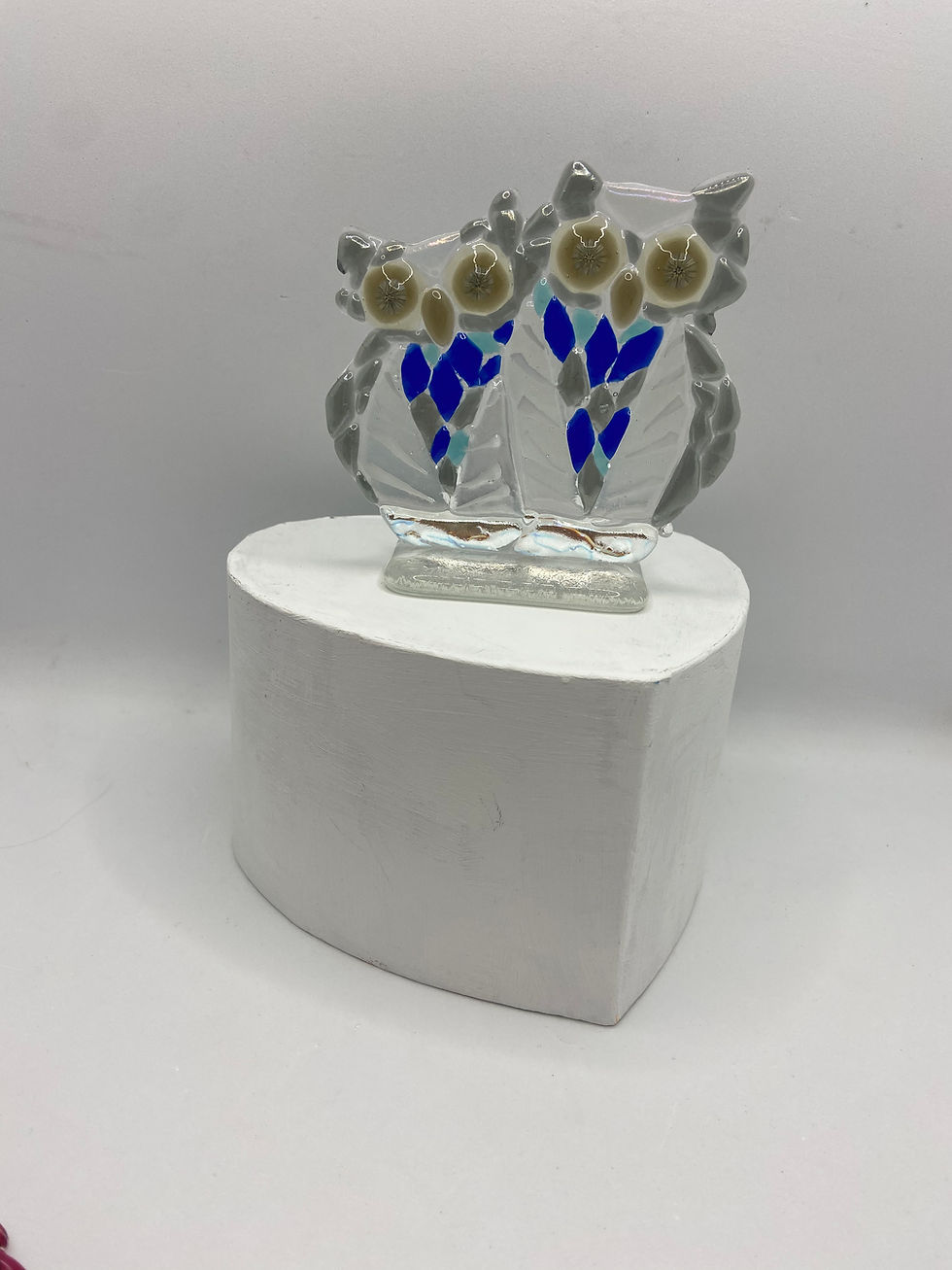 fused glass owls in dark blue mounted on a glass stand