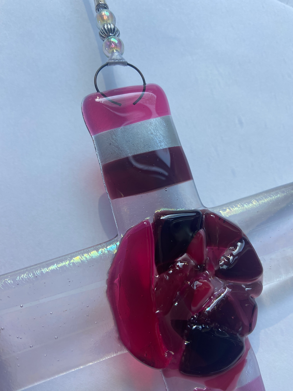 Thumbnail: fused glass cross with a bright pink rose detail