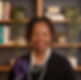 Sharon, a smiling Black woman with pearls and purple brooch