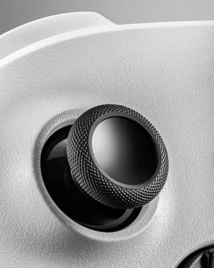 Close-up of xbox controller joystick detail on white surface
