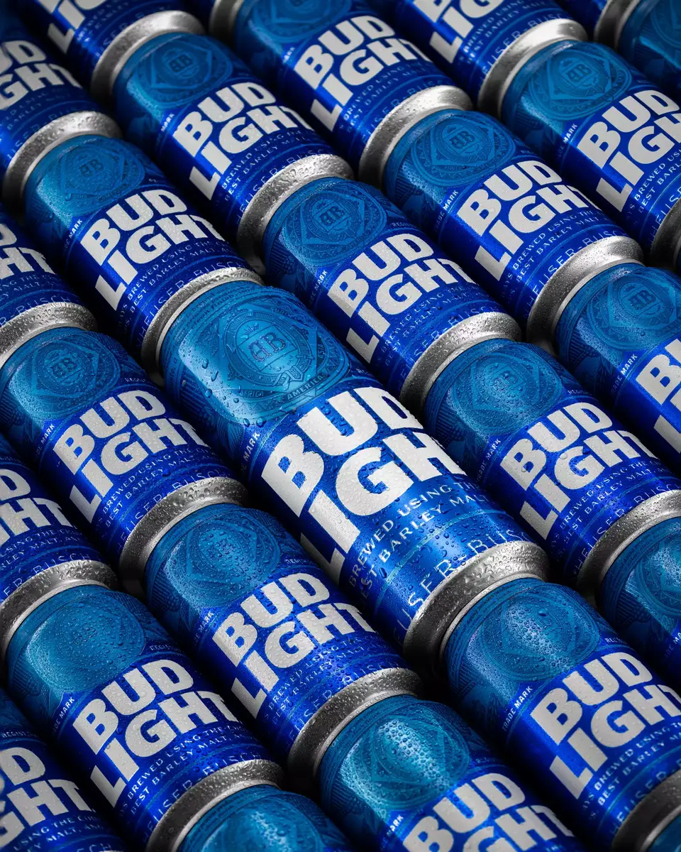 Repetitive pattern commercial shot of Bud Light cans with high-contrast blue lighting