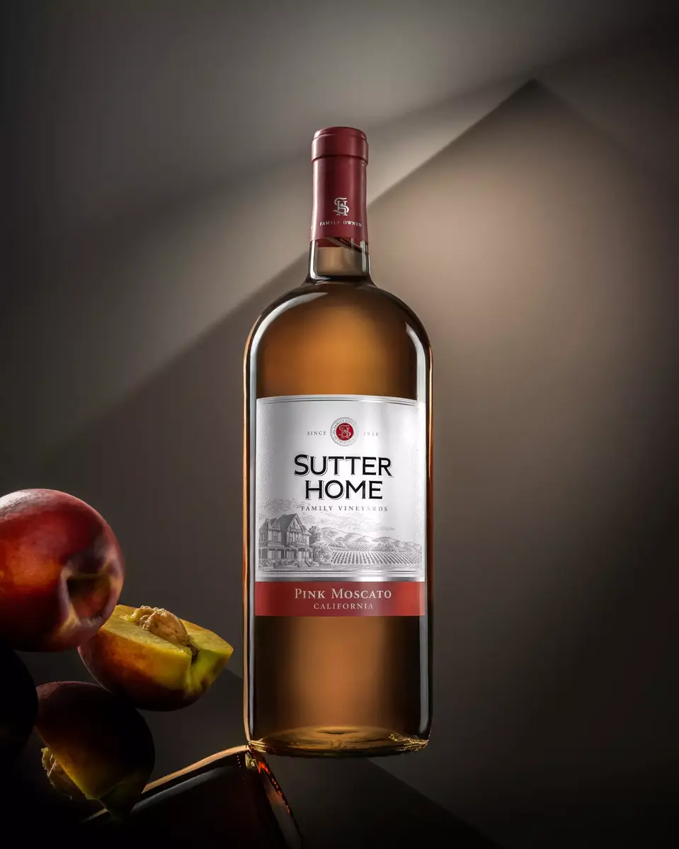 Professional bottle photography of Sutter Home wine featuring soft rim lighting and natural grape accents