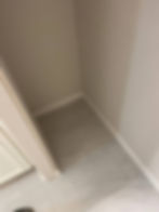 Close-up of light gray floor tiling in a room corner