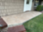 Stone patio entrance with white door and shingle siding