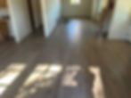 Newly installed light wood laminate flooring in a room