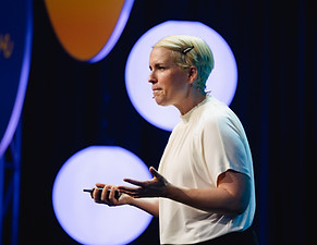 Keynote speaker on stage at a corporate event, photographed by Olivia Cameron
