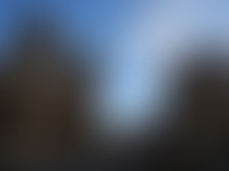 View of Bristol Cathedral and elegant buildings on College Street with a blue sky and fluffy clouds