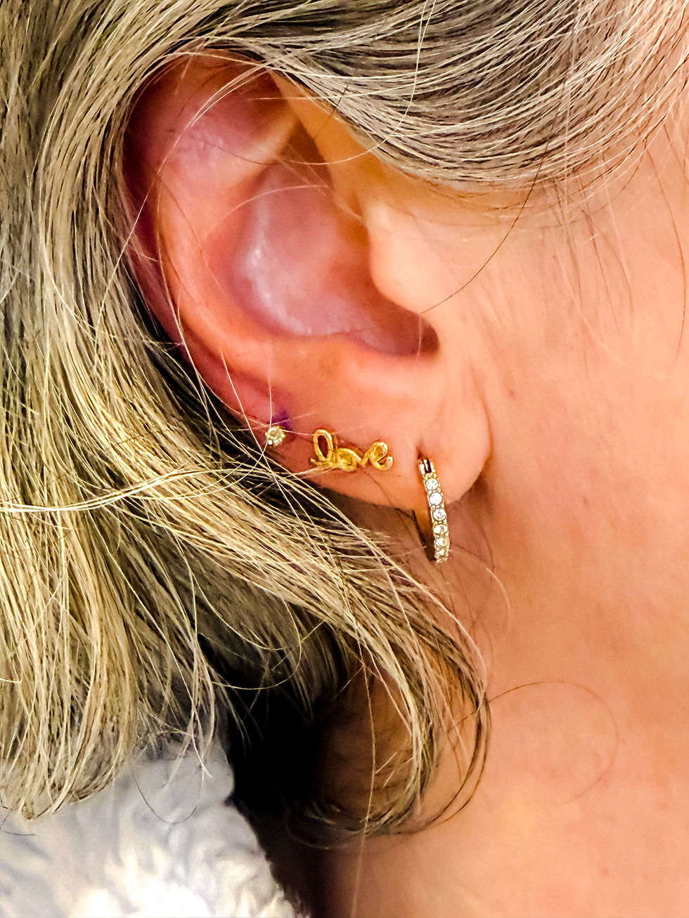 All That Glitters boutique ear piercing client with three lobe piercings