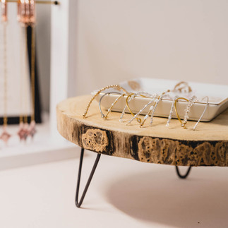 wooden tray with permanent jewelry bangles