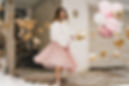 Leanne Kampfe wearing a white jacket and pink skirt; photo credit: engle//olson