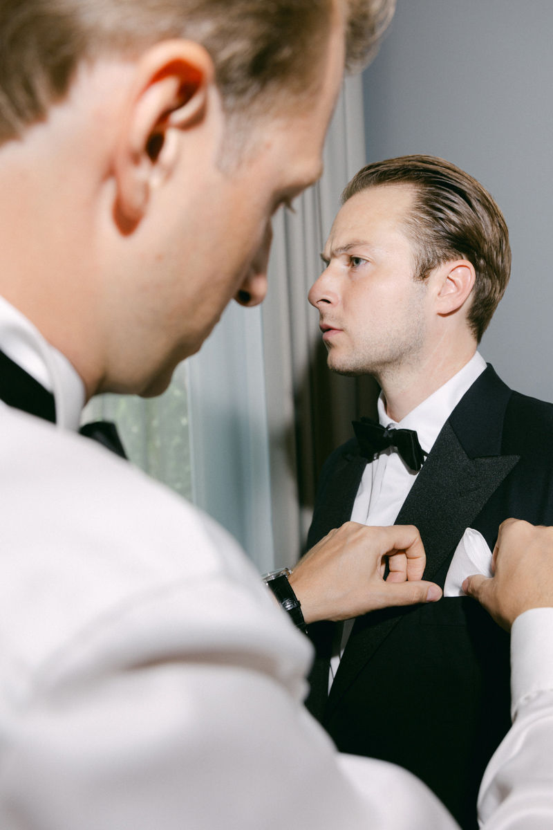 groom's best. man helps him to get ready wedding photography