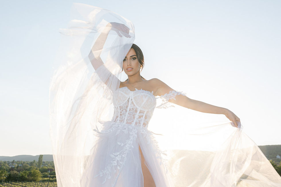 Eye-level view of a photographer capturing a bride in a sunlit vineyard