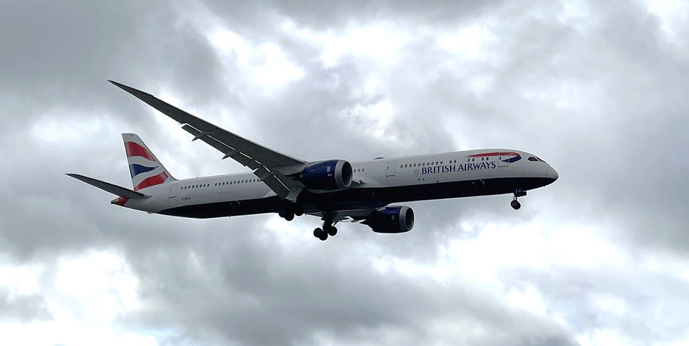 White British Airways jet with landing gear down flies through cloudy sky. Farnborough 2026 was a moment for the variant.