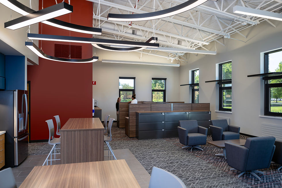 new breakroom and work spaces in Queen Bee School District 16 operations center, featuring bar-height seating, lower lobby seating and desks