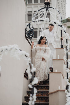 Bride and groom walking down stairs at The Oviatt.