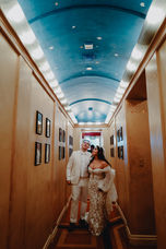 Bride and groom walking in The Oviatt hallway.