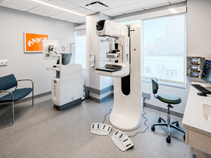 Mammography technologist preparing a patient for a mammogram at a Hamilton diagnostic clinic