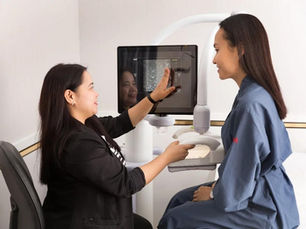 Radiologist reviewing a mammogram showing dense breast tissue at a Hamilton imaging clinic
