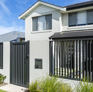 Modern aluminium slat fencing and gate on a Sydney home, combining privacy with a sleek contemporary look