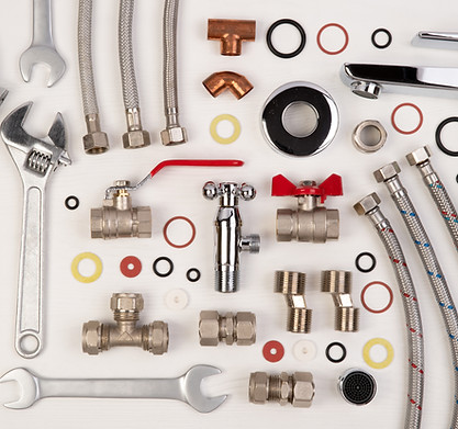 Plumber tools and spare parts on white wooden background, top view, flat lay .jpg