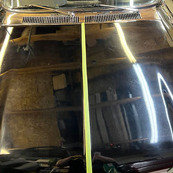 Side by side of paint correction on black car