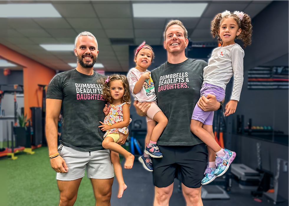 Will and his trainer Julian smiling as they hold their daughters, celebrating Will's fitness journey and family-focused motivation.