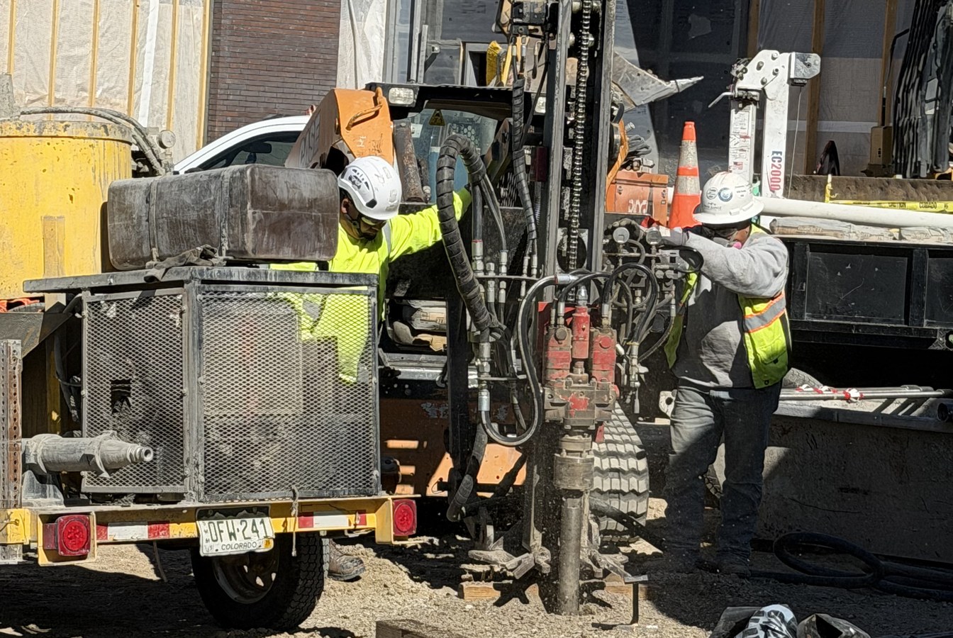 Park Range crew drilling a micropile with a skid-steer-mounted rig at Erie Fire Station No. 15