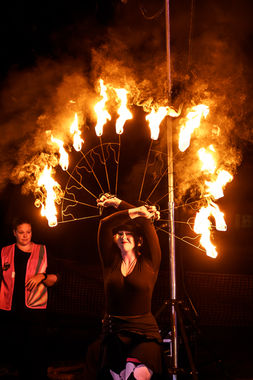 Kat holding some giant fans of fire