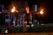 Kat in the hat posing with 2 top hats on fire